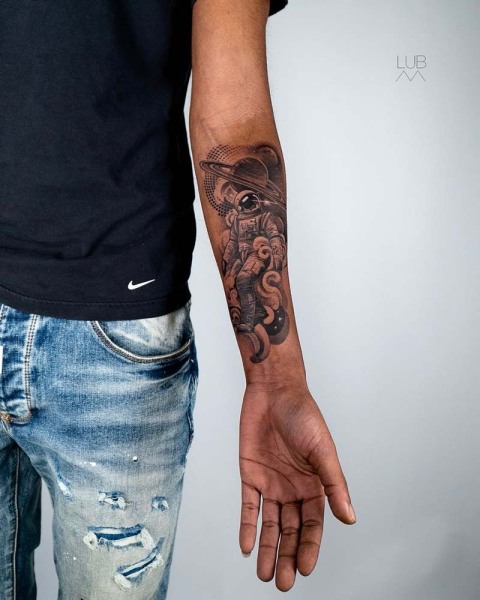 Exploring new horizons: A detailed illustrative astronaut piece with fine-line Saturn rings. One of our favourite tattoo ideas for men this year.