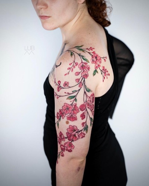 A masterpiece in bloom: This custom cherry blossom piece by Lubava features delicate pink shading and an organic flow that complements the natural anatomy.