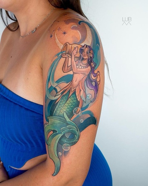 A celestial masterpiece in color: This custom illustrative piece by Lubava blends a powerful mermaid pouring water with an Aquarius zodiac theme and constellation.