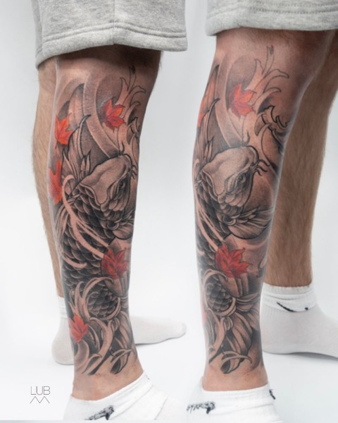 Flow and Strength: A custom Japanese-inspired koi fish leg piece by Lubava, featuring deep black and grey shading contrasted with striking red autumn leaves.