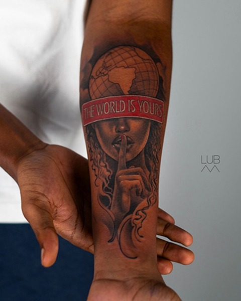 A bold statement in ink: This custom 'The World Is Yours' piece by Lubava blends intricate illustrative portraiture with a striking red banner and globe design.