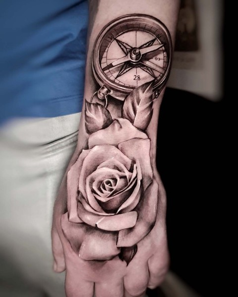 Black and grey realistic compass and rose tattoo at Silent Moon, Bermondsey.