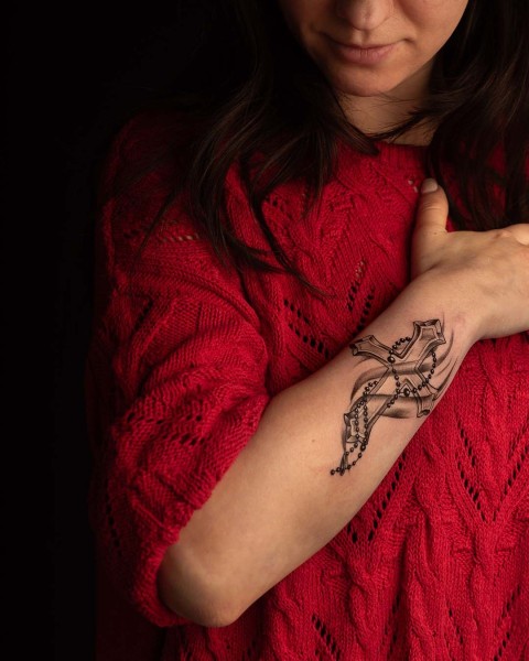 Black and grey gothic cross and rosary tattoo at Silent Moon, our private tattoo studio in Bermondsey, South East London.