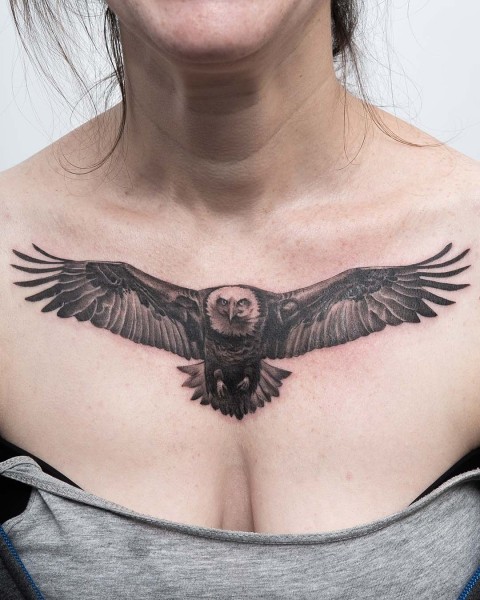 Black and grey realistic owl chest tattoo with spread wings at Silent Moon, our private tattoo studio in Bermondsey, South East London.