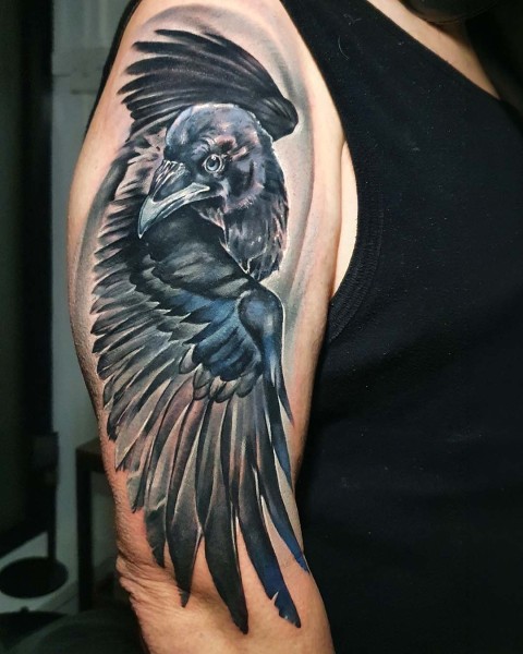 Colour realism raven tattoo with blue iridescent feathers at Silent Moon, our private tattoo studio in Bermondsey, South East London.